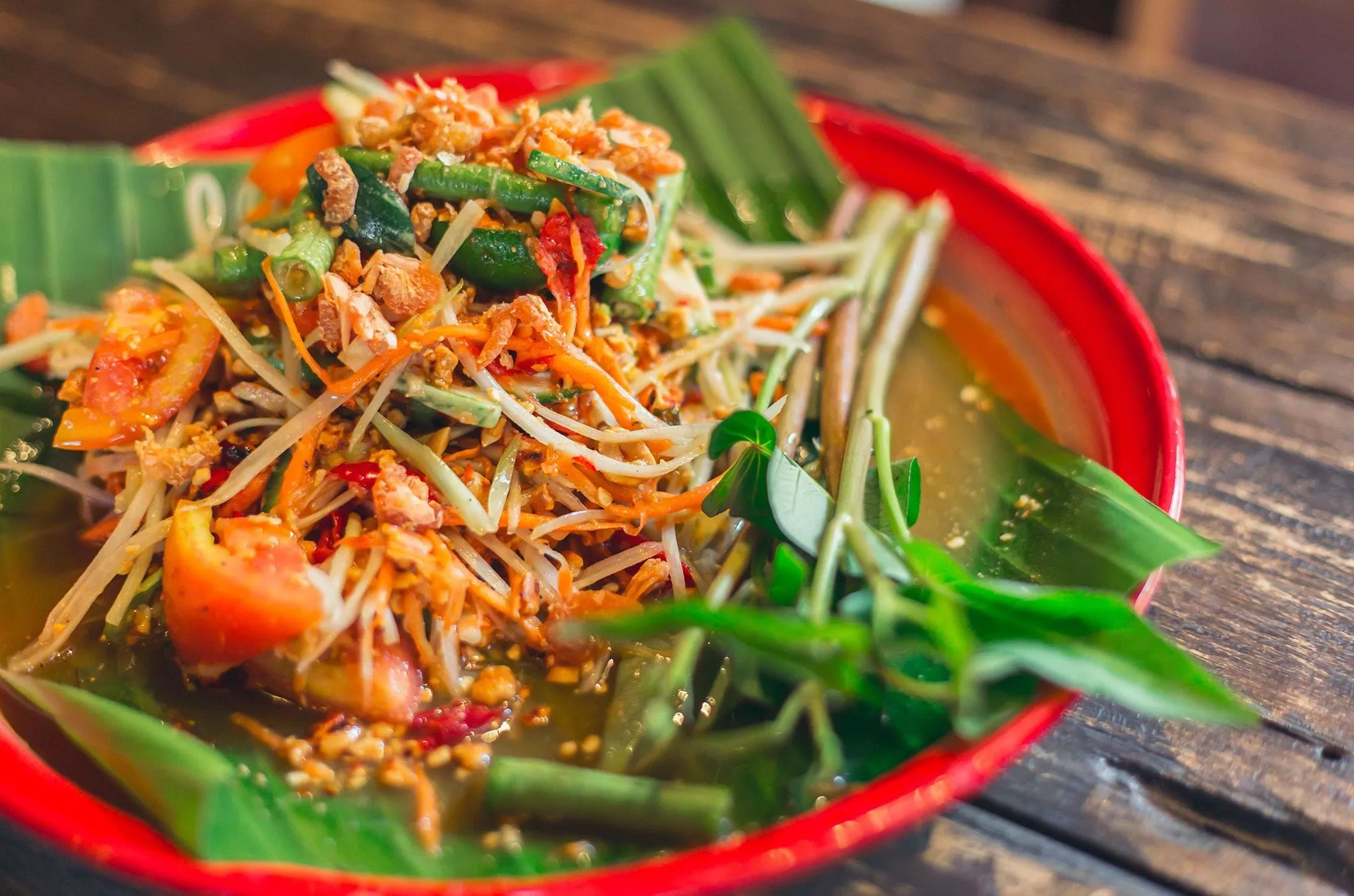 Thailändische Spezialität mit laotischen Wurzeln: som tam, ein Salat auf Grundlage von Papayastreifen und Tomaten