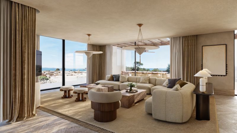 Luxus-Living Room im Amoh Resort Rhodes: beige Sofagruppe, quadratische Holztische, Deckenlampen, bodentiefe Fenster mit Meeresblick.