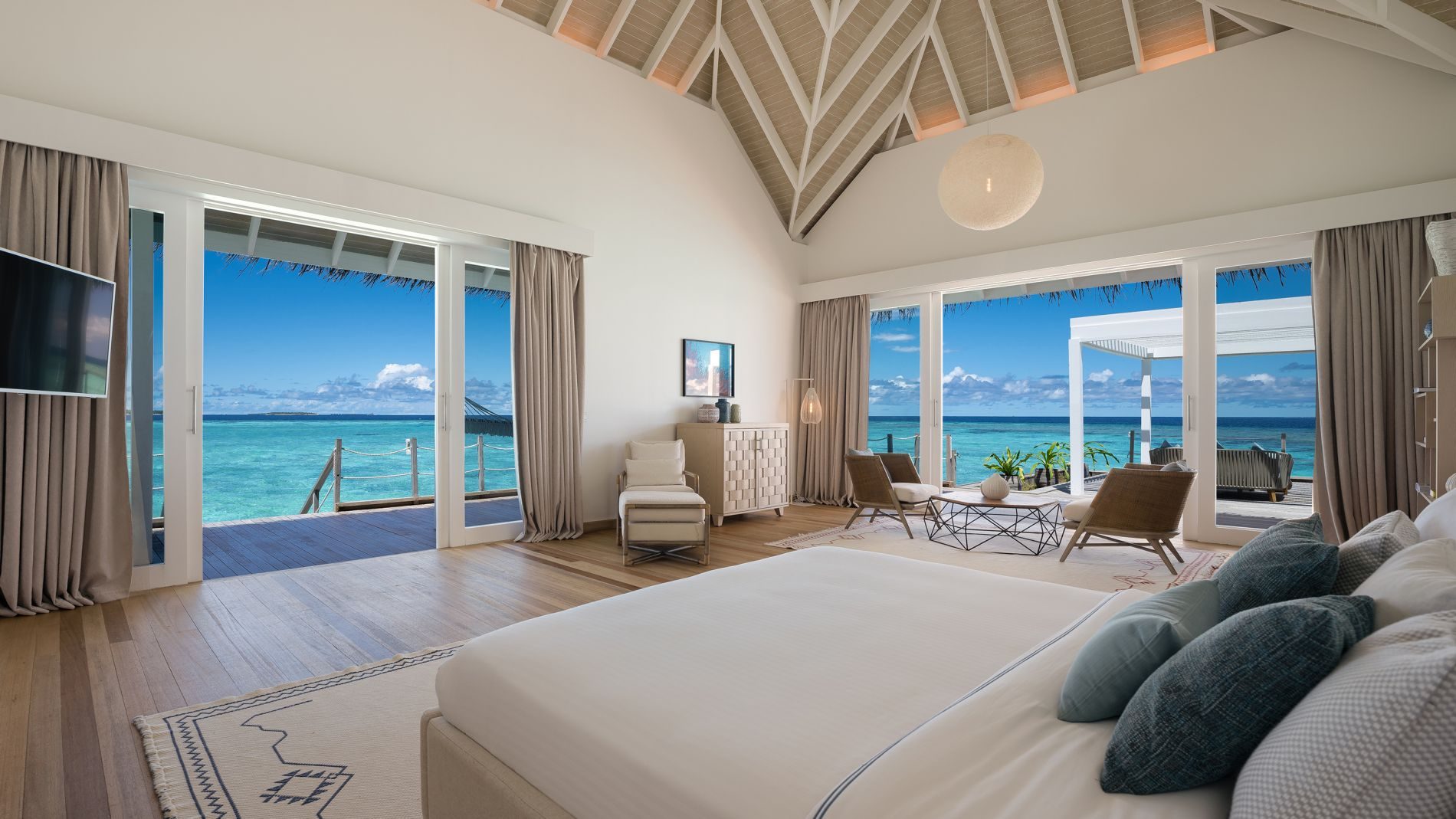 Luxus-Villa im Baglioni Maldives: Schlafzimmer mit Meerblick, Lounge-Bereich, große Glasfronten zur Terrasse und offener Ozeanblick